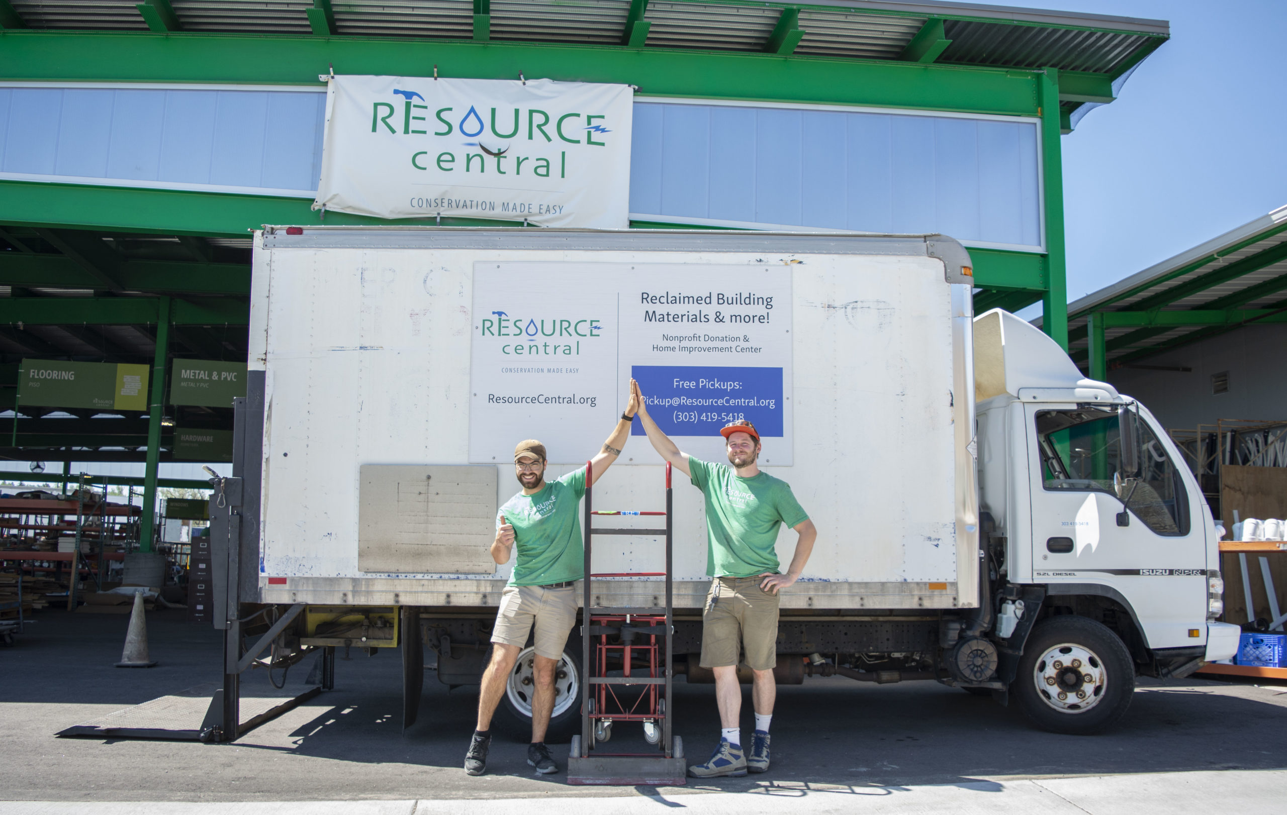Resource Central awning and truck with two employees wearing green shirts.