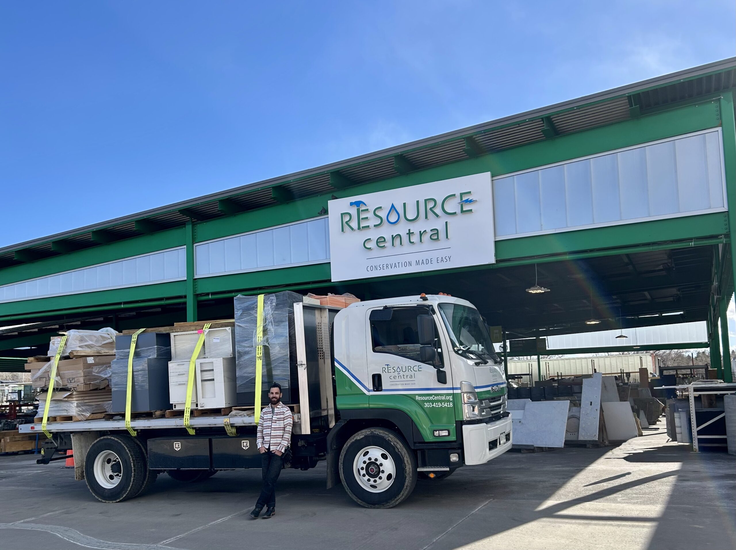 A flatbed truck loaded full of building materials in front of the Resource Central facility. Free building materials pickup