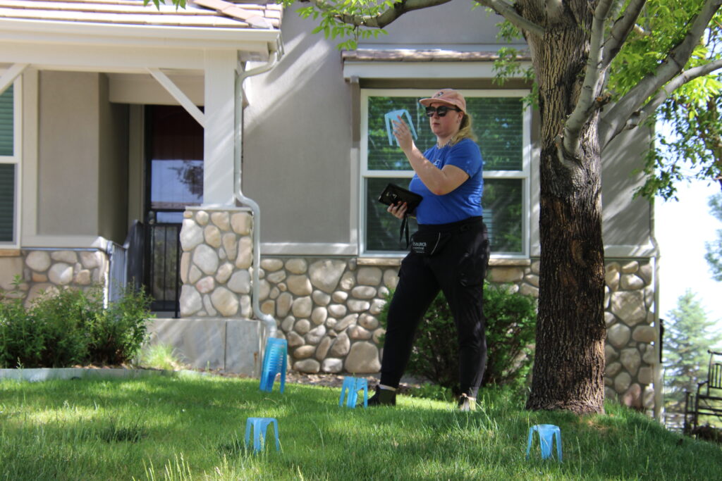 A technician conducting a water efficiency test in a grass yard.