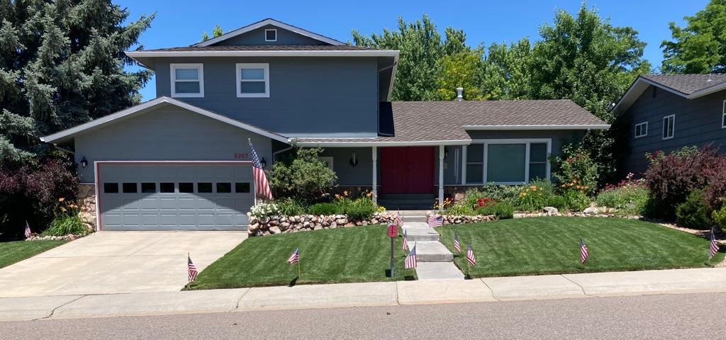 A house with a traditional green grass lawn.