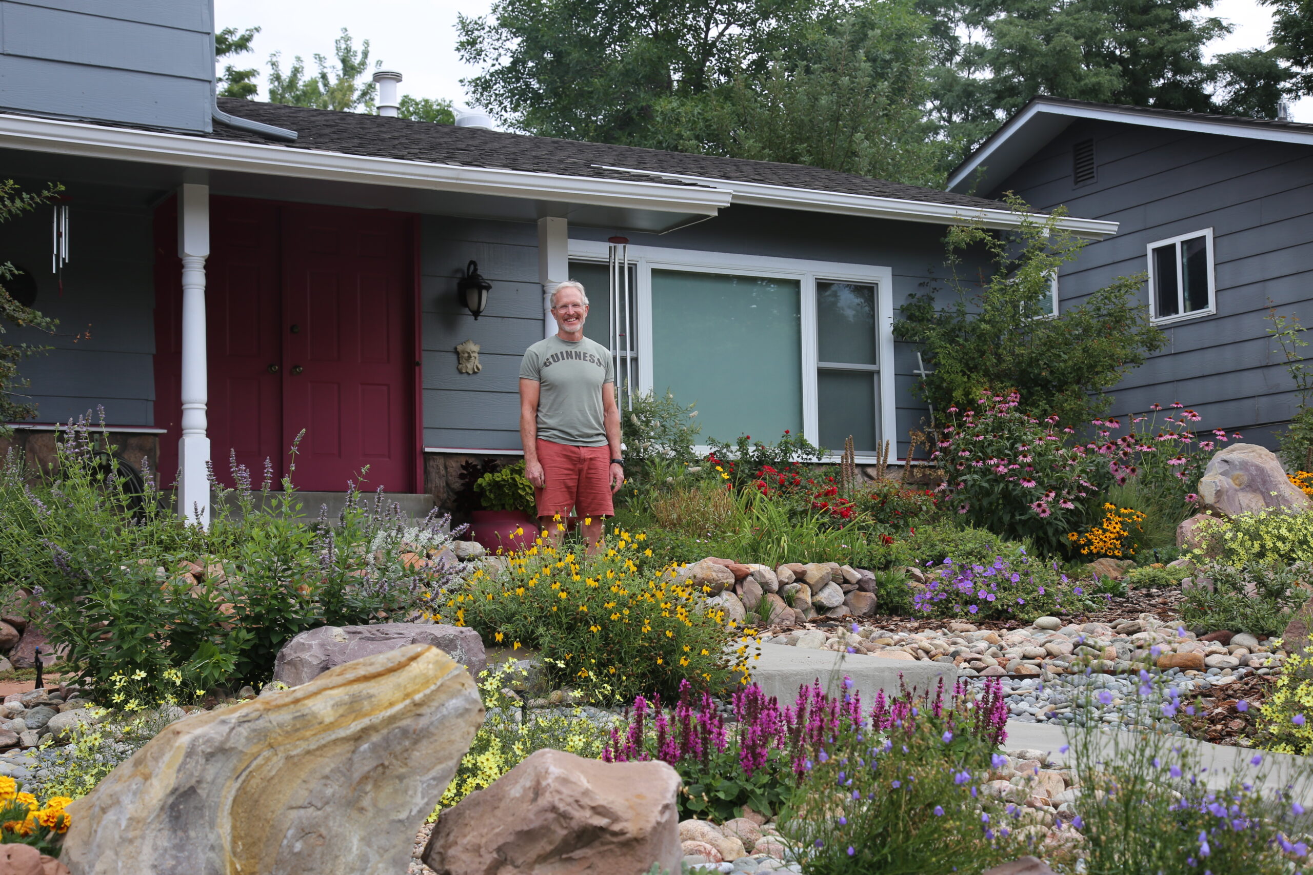 A man standing in his waterwise garden