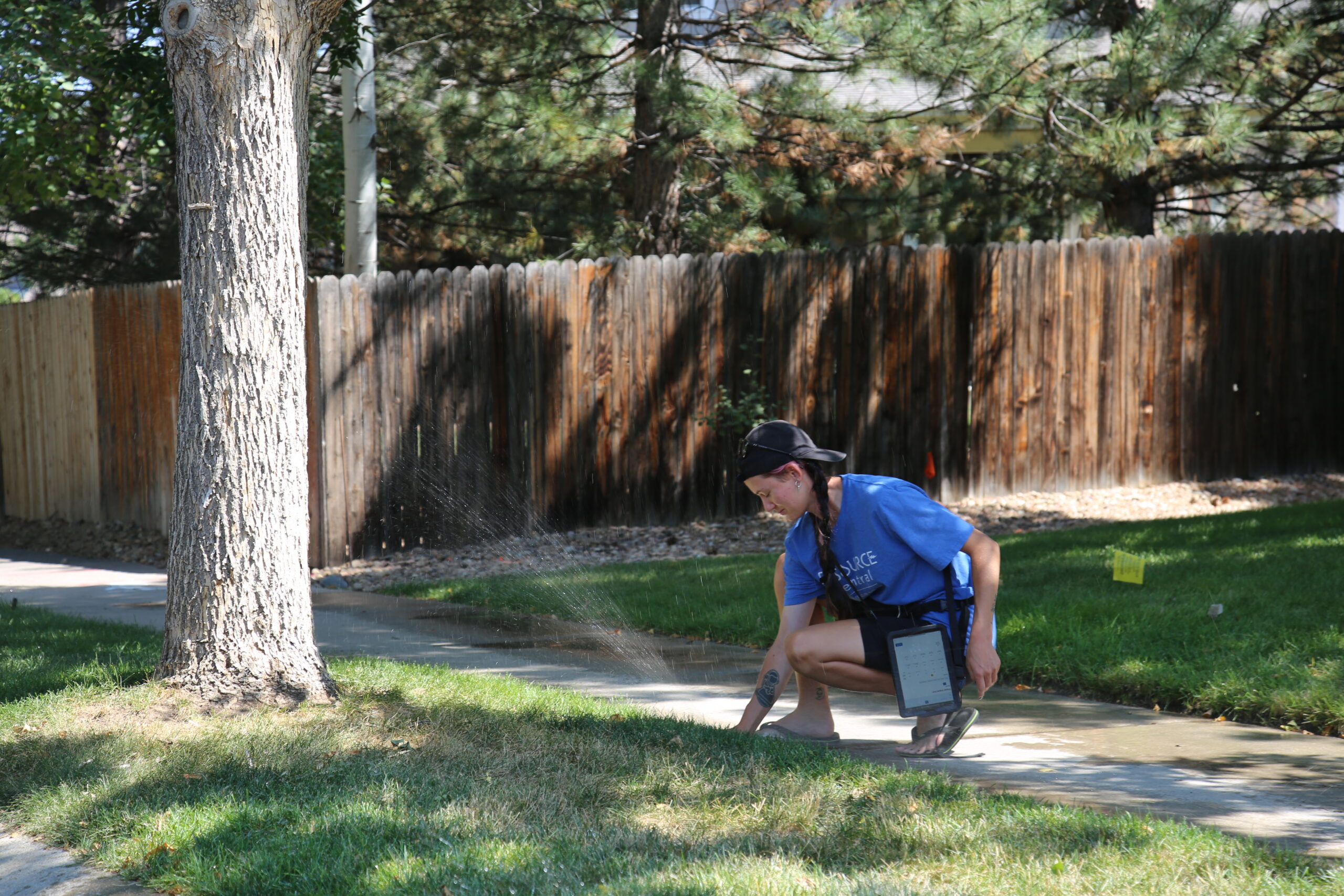 A Slow the Flow technician inspects a sprinkler head.